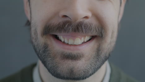 close-up of a smiling man with a mustache and beard