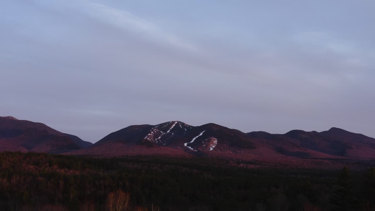 Drone Aerial of ski mountain after season close at sunset golden hour 4k 30p