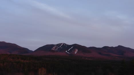drone aerial of ski mountain after season close at sunset golden hour 4k 30p