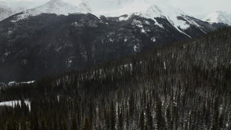 Berthoud-Berthod-Jones-Pass-Winter-Park-snowy-winter-Colorado-high-elevation-aerial-cinematic-drone-Rocky-Mountains-Peak-i70-scenic-landscape-view-HWY-80-roadside-national-forest-forward-pan-up-motion