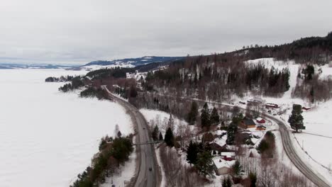 Wide-aerial-showing-Norwegian-cold-climate-and-highway-in-moving-drone-shot
