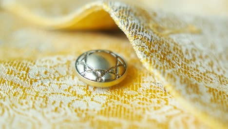 close-up of a button on a yellow fabric