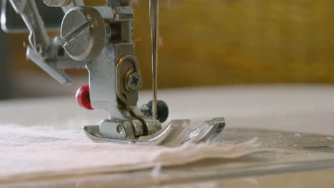 CLOSE-UP-of-a-sewing-machine-running-and-stopping-as-it-reaches-an-edge