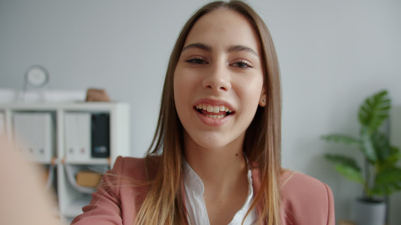 Woman taking a selfie in an office setting