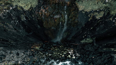 aerial view of waterfall cascading down cliffside