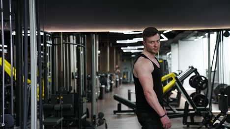brutal guy in sportscenter. handsome sportsman with muscular body in the modern fitness center. sportive lifestyle.
