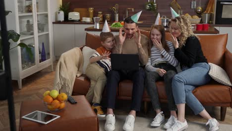 cheerful deaf family during video chat at laptop