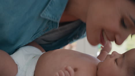 close up mother kissing baby laughing enjoying loving mom nurturing her toddler showing love at home