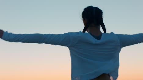 young-woman-with-arms-raised-on-mountain-top-enjoying-freedom-celebrating-achievement-girl-looking-at-beautiful-view-of-ocean-at-sunset