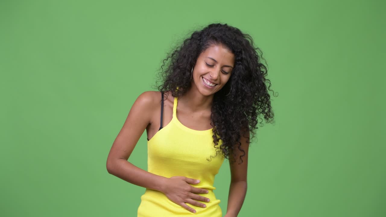 Young happy beautiful Hispanic woman laughing