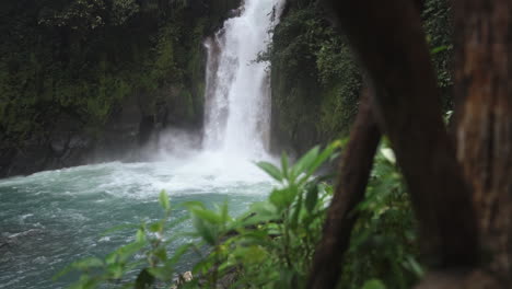 slow motion shot pushing through railing at rio celeste waterfall costa rica