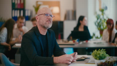 Contemplative-manager-sitting-in-office.