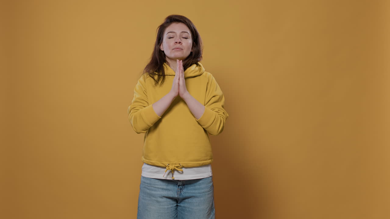 Woman praying in studio