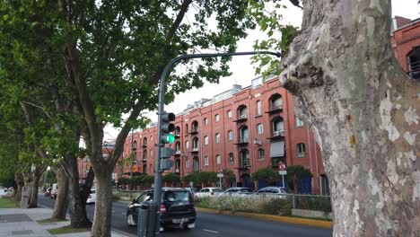 city street with red brick buildings and green trees