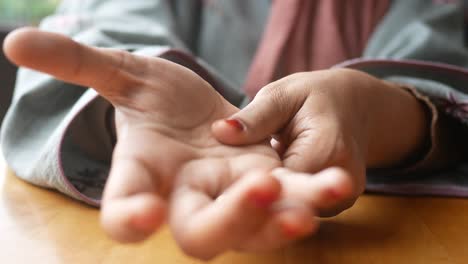 woman's hands resting on a table