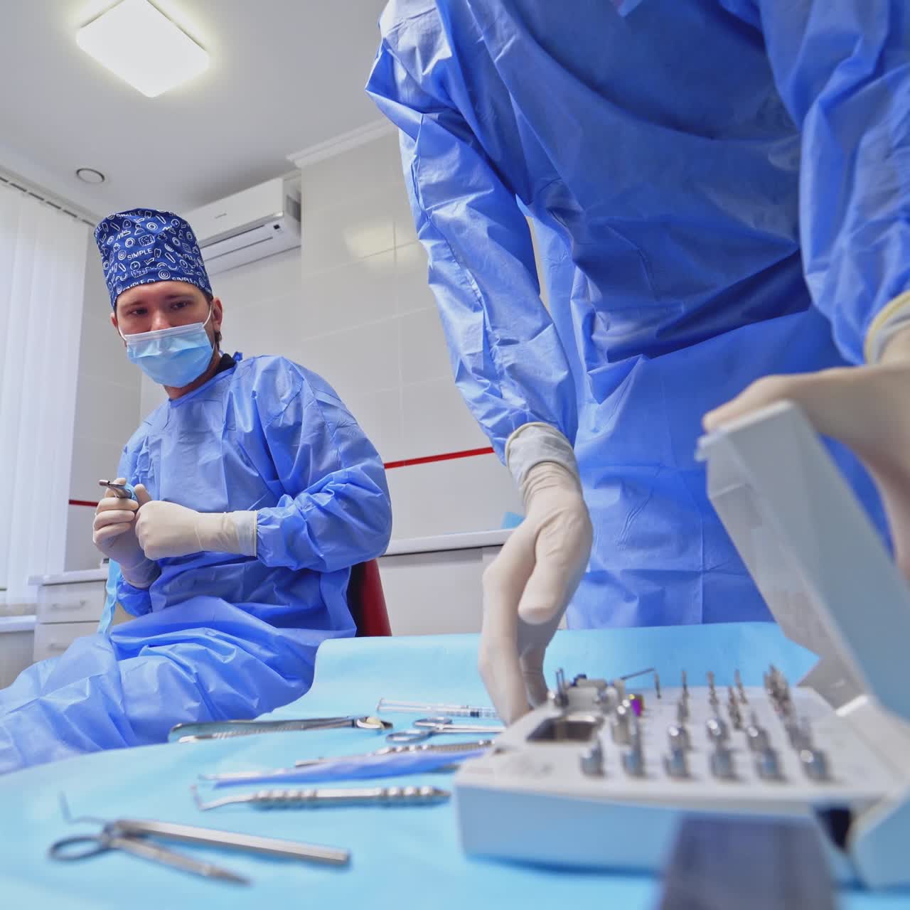 Dentist preparing equipment for surgery