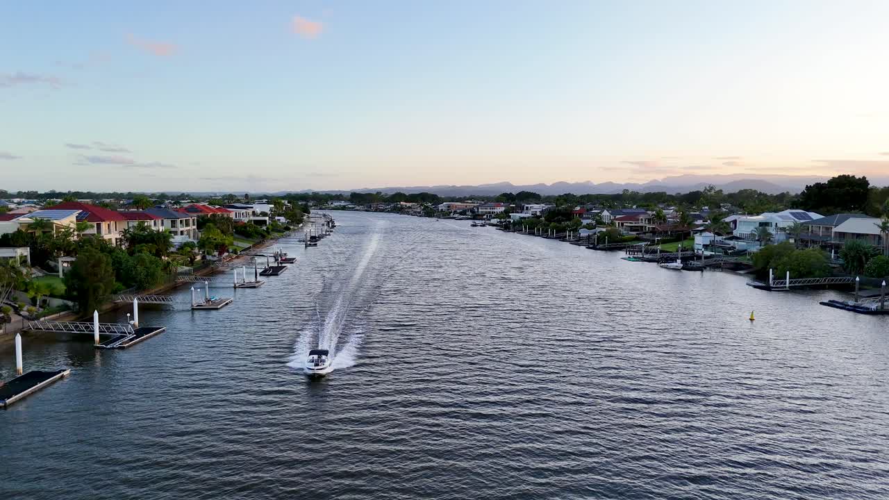 Boats cruising along scenic Nerang River