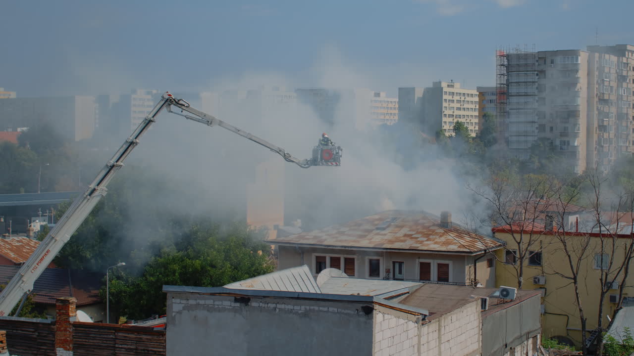 Team of firefighters on service to put out fire from burning house