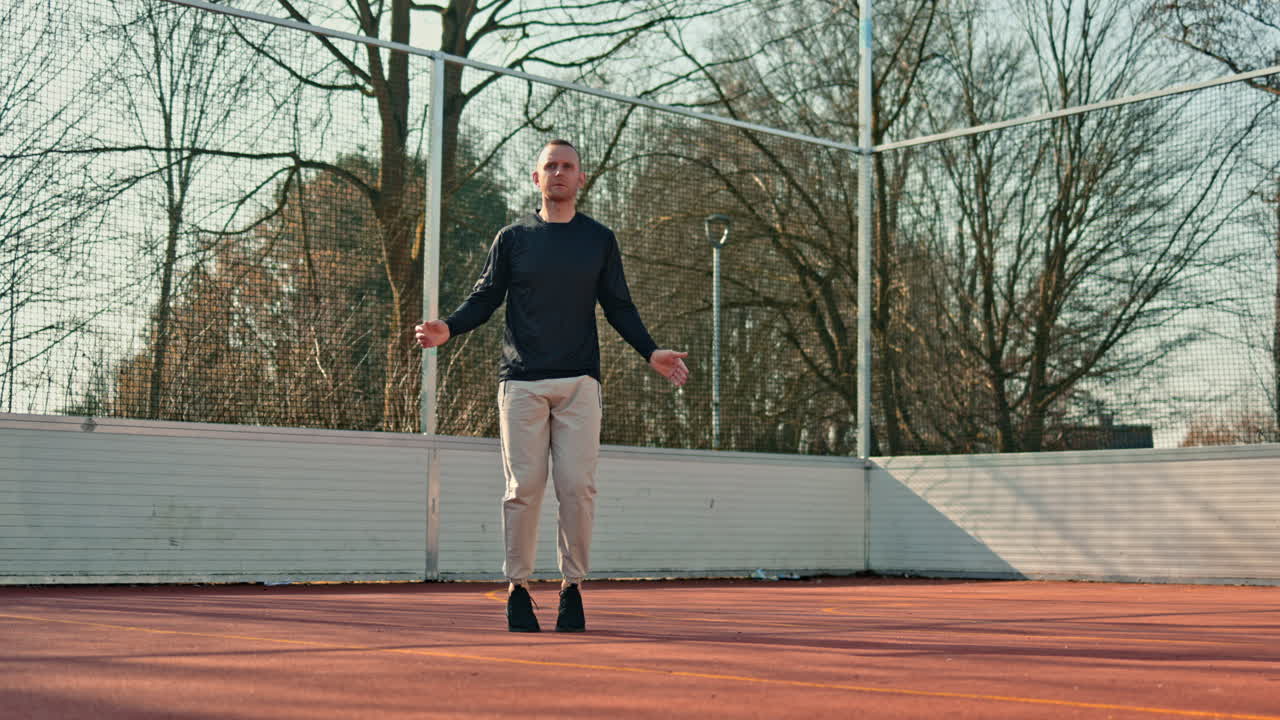 Young athletic man doing sports on the open-air playground. Healthy lifestyle. Man in sportswear doing physical exercises