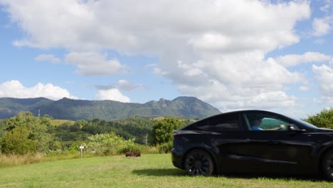 black car travels across picturesque countryside