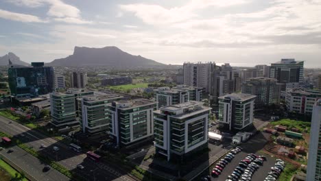 ebene, mauritius with modern buildings and mountain backdrop, sunny day, aerial view