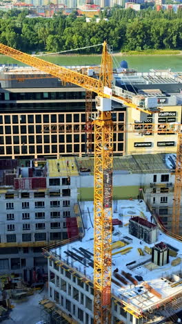 crane at city construction site. a tall crane operates at a bustling construction site in an urban area, showcasing new building developments