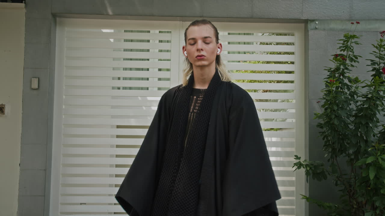 Portrait of Gen Z Man in Black Urbanwear Posing Outdoors