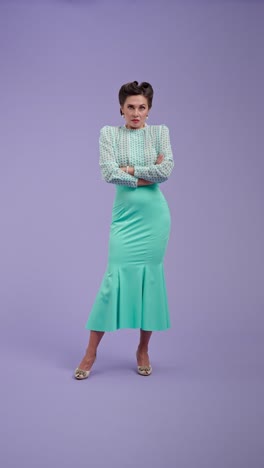 elegant woman in vintage-style outfit posing on purple background
