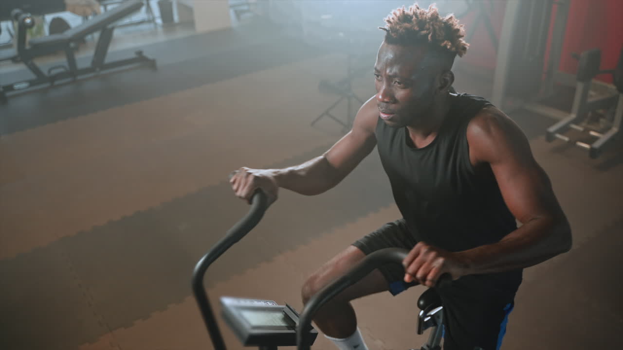 Man working out on an exercise bike in a gym
