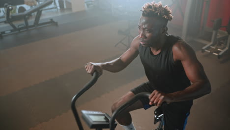 man working out on an exercise bike in a gym