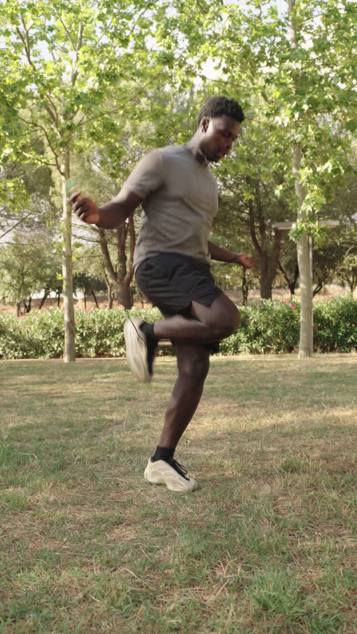 Man Exercising Outdoors with Jump Rope and Resistance Band