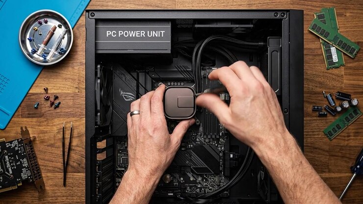 Hands installing computer hardware components inside desktop computer case