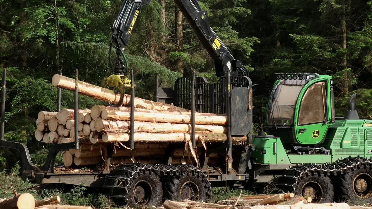 Forestry harvester loading timber mid-shot, Highlands, Scotland
