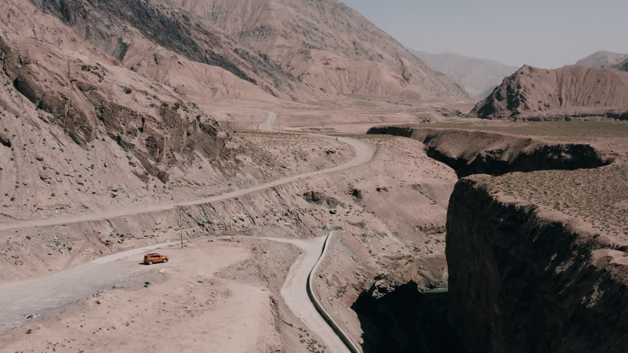 kun lun da xia gu canyon 절벽, 조감도에 주차된 주황색 4x4 오프로드 자동차