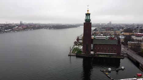 aerial pan across stockholm city center with prominent tower and golden weather vane