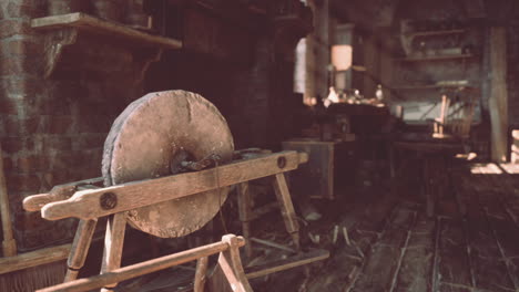 a close-up view of a vintage stone grinder in a rustic workshop