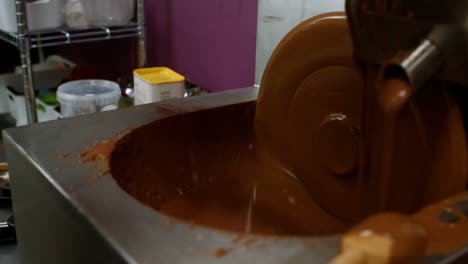 worker filling mould with melted chocolate