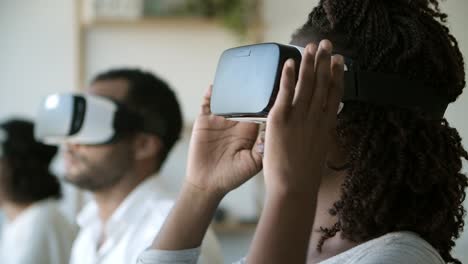 Smiling-woman-experiencing-virtual-reality-headset.