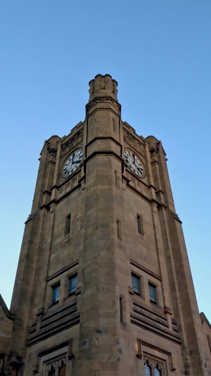 Clock tower against clear blue sky