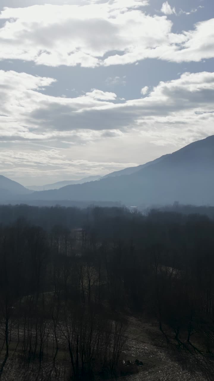 Mountain landscape with trees and clouds