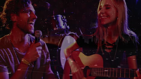 music duo performing under stage lights, holding mic and strumming guitar with star particles