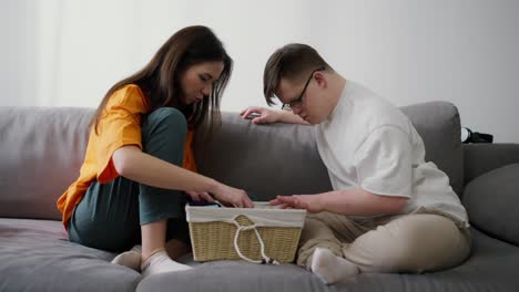 Sister-and-brother-together-at-living-room,-funny-activity-at-living-room,-inspecting-box-together