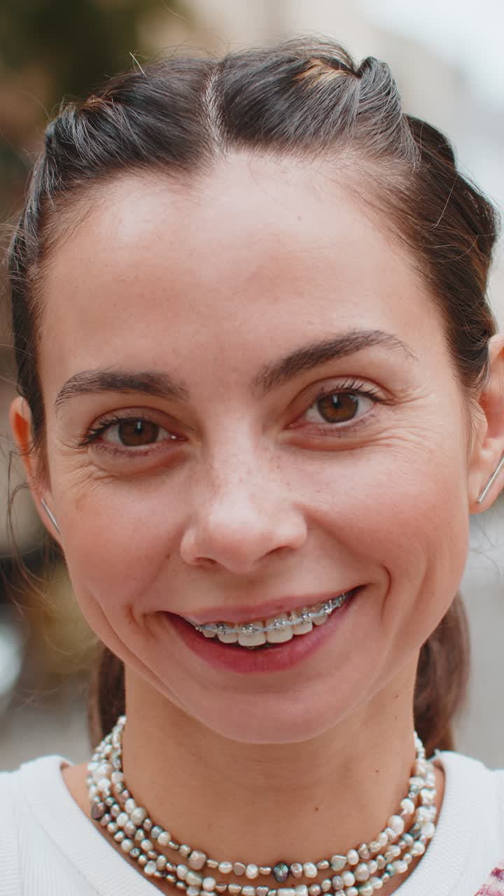Portrait of happy woman face with braces on teeth smiling open eyes glad expression looking dreaming