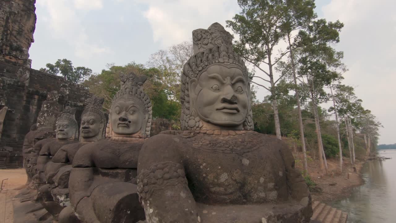 The many faces statue of Angkor Thom leading to the south gate.  Dolly in
