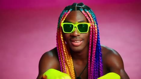 stylish man with colorful braids and sunglasses