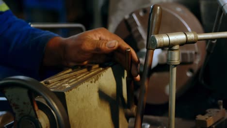 metalsmith working on machine in workshop 4k