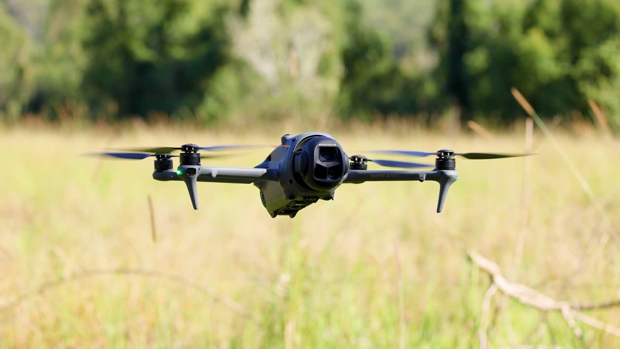 A drone hovers and turns in a sunlit field, capturing the serene landscape of Gold Coast, Australia