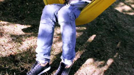 man sitting in a hammock outdoors