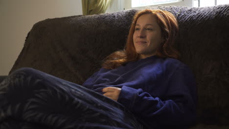 woman relaxing on a couch at home
