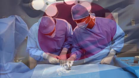 Animation-of-flag-of-japan-waving-over-surgeons-in-operating-theatre